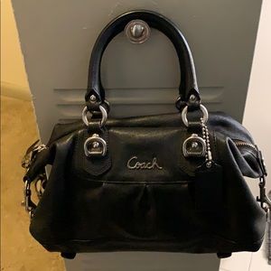 Black coach bag. Purple lining